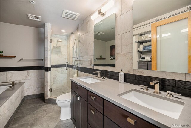 1925 W 32nd Ave Unit 404, Denver, CO 80211 - full bathroom featuring tile walls, a stall shower, double vanity, toilet, and a relaxing tiled tub