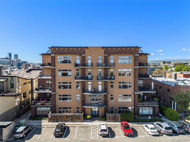 1925 W 32nd Ave Unit 404, Denver, CO 80211 - view of building exterior featuring uncovered parking and a city view