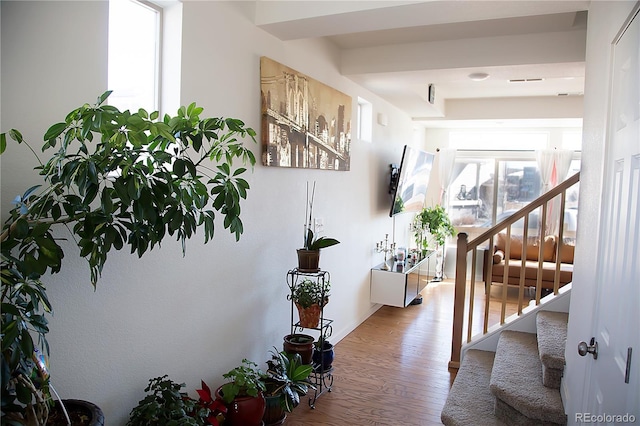 corridor featuring stairway and wood finished floors