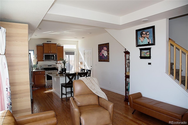 living room featuring baseboards, stairs, and dark wood-style flooring