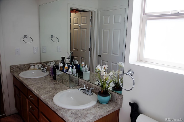 bathroom featuring double vanity and a sink