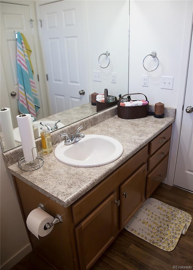 bathroom featuring vanity and wood finished floors