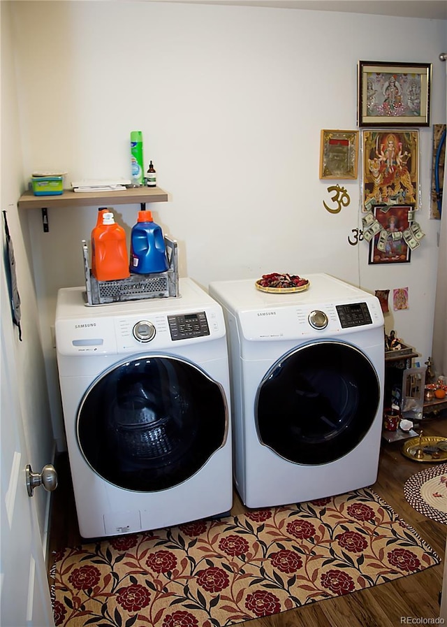 laundry area featuring washing machine and dryer, laundry area, and light wood-type flooring