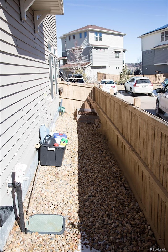 view of yard with a residential view and fence