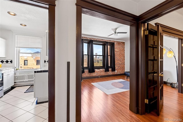 1475 N Humboldt St Unit 20, Denver, CO 80218 - corridor featuring brick wall, light wood finished floors, and a healthy amount of sunlight