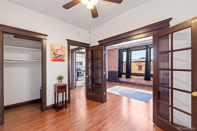 1475 N Humboldt St Unit 20, Denver, CO 80218 - bedroom featuring french doors, wood finished floors, baseboards, crown molding, and ceiling fan