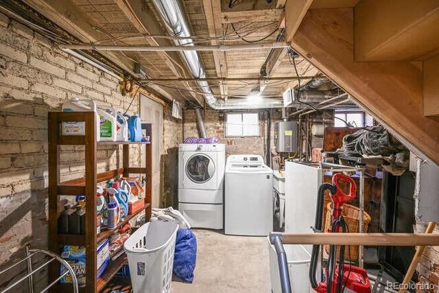 1027 S University Blvd, Denver, CO 80209 - laundry area with washing machine and clothes dryer, laundry area, and brick wall