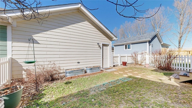 exterior space with a lawn and fence