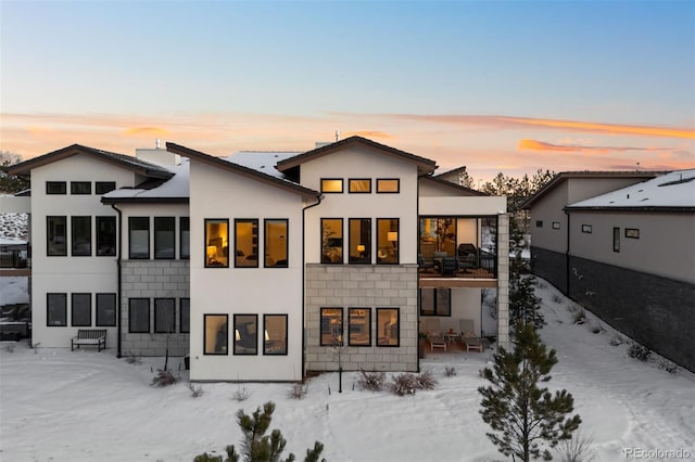 view of snow covered rear of property