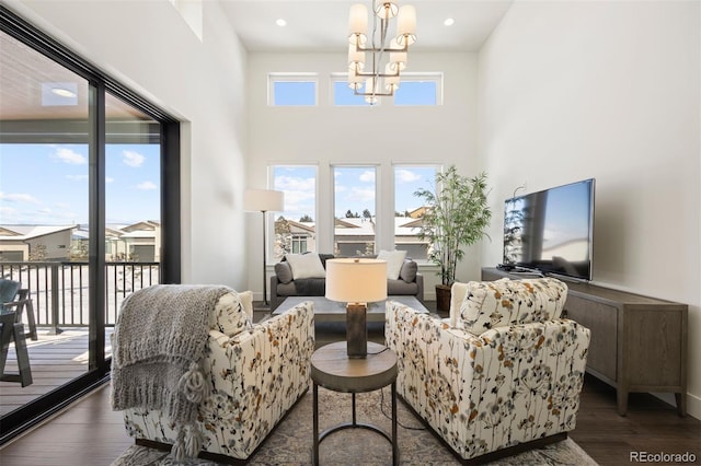 living room with a notable chandelier and dark hardwood / wood-style floors