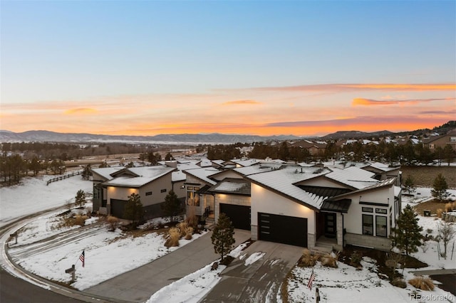 snowy aerial view with a mountain view