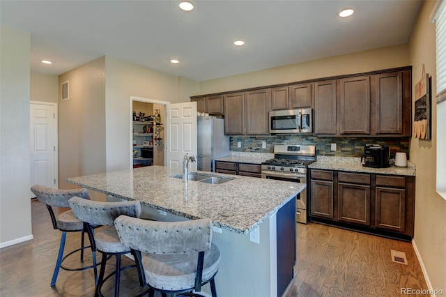 5837 High Timber Cir, Castle Rock, CO 80104 - kitchen with light wood finished floors, visible vents, a sink, and appliances with stainless steel finishes
