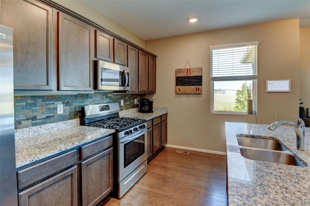 5837 High Timber Cir, Castle Rock, CO 80104 - kitchen with plenty of natural light, light wood-style flooring, stainless steel appliances, and a sink