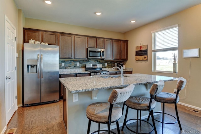 5837 High Timber Cir, Castle Rock, CO 80104 - kitchen featuring dark wood finished floors, visible vents, stainless steel appliances, and a sink