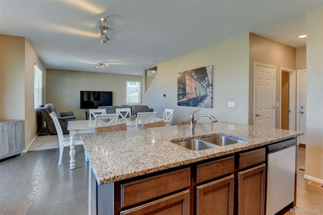 5837 High Timber Cir, Castle Rock, CO 80104 - kitchen featuring dishwasher, wood finished floors, plenty of natural light, and a sink