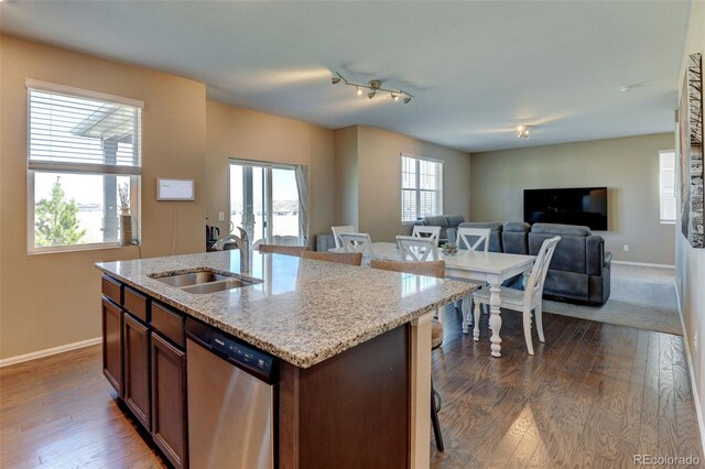 5837 High Timber Cir, Castle Rock, CO 80104 - kitchen featuring stainless steel dishwasher, open floor plan, a sink, and baseboards