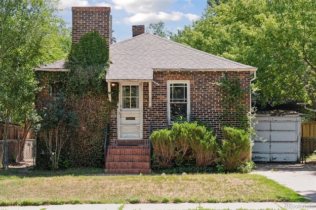 712 Locust St, Denver, CO 80220 - view of front facade with a chimney, a shingled roof, and brick siding
