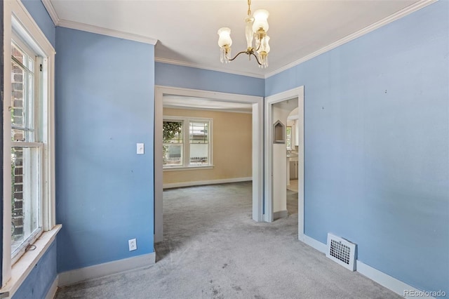 712 Locust St, Denver, CO 80220 - carpeted spare room featuring a chandelier, arched walkways, and ornamental molding