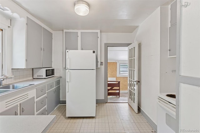 712 Locust St, Denver, CO 80220 - kitchen featuring white appliances, light countertops, gray cabinetry, and tasteful backsplash