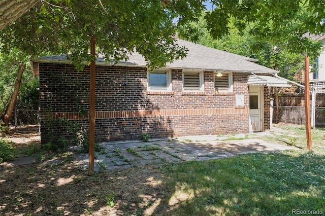 712 Locust St, Denver, CO 80220 - view of front of property featuring brick siding, a patio, and a shingled roof