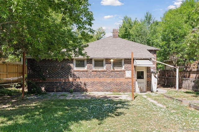 712 Locust St, Denver, CO 80220 - view of front of home with brick siding, a fenced backyard, a chimney, and roof with shingles