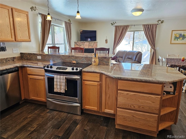 kitchen with dark wood-style floors, stainless steel appliances, open floor plan, and a healthy amount of sunlight