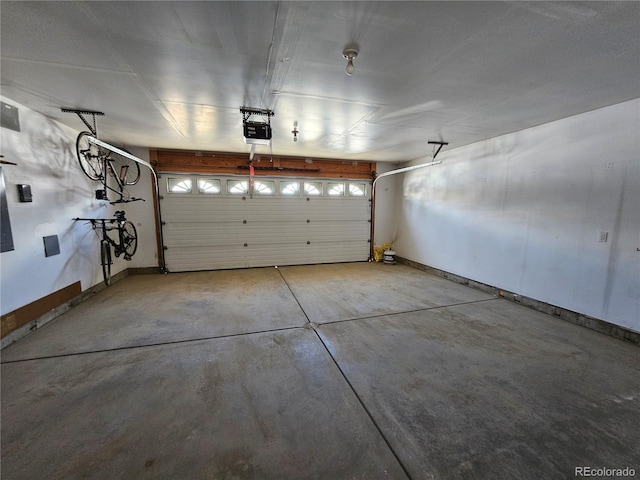 garage featuring baseboards and a garage door opener