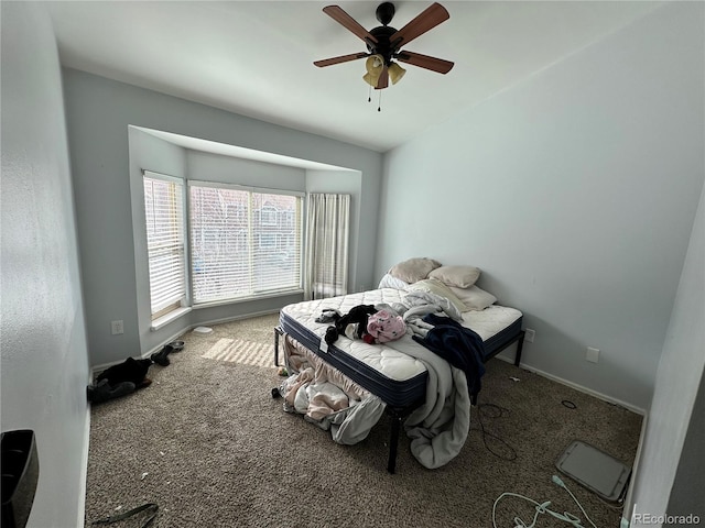 bedroom featuring carpet, baseboards, and a ceiling fan