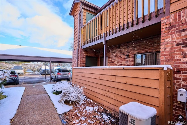 snow covered property with a balcony