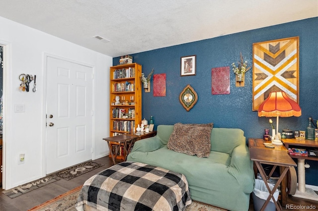 interior space with hardwood / wood-style flooring and a textured ceiling