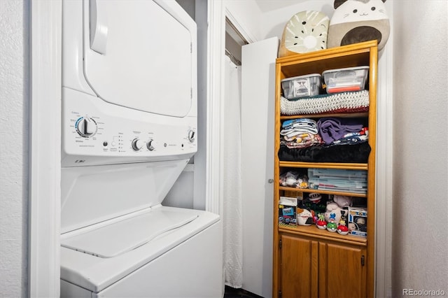 laundry area with stacked washer and clothes dryer