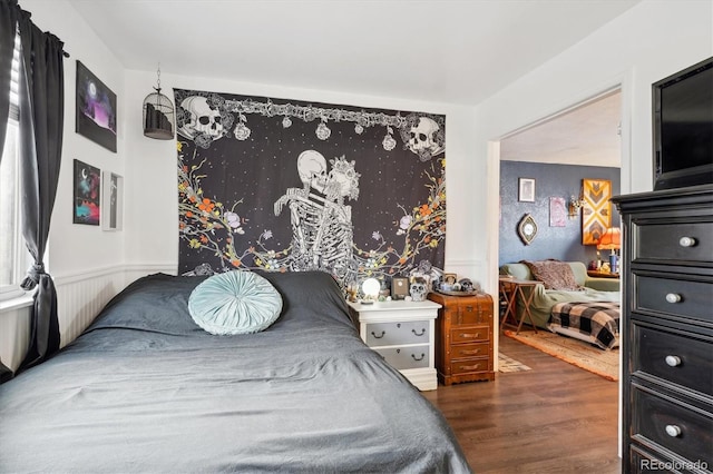 bedroom with dark hardwood / wood-style flooring