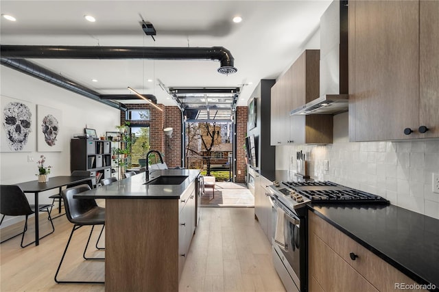 1242 Yates St Unit U2, Denver, CO 80204 - kitchen with light wood finished floors, dark countertops, stainless steel gas range oven, and a sink