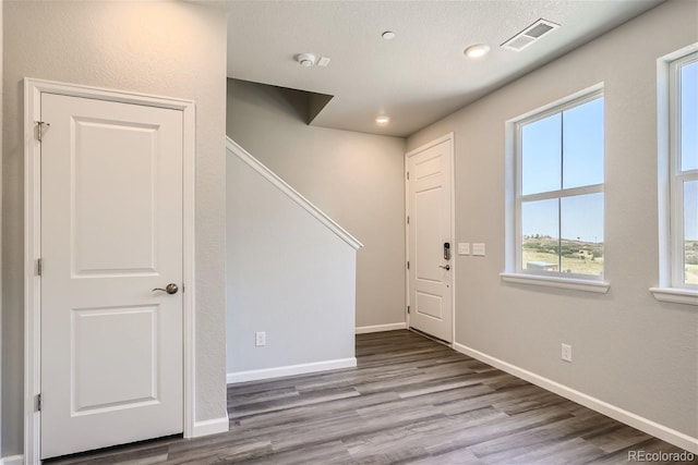 foyer with a textured ceiling and light hardwood / wood-style flooring