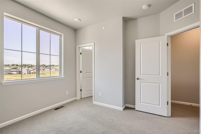 unfurnished bedroom with light colored carpet