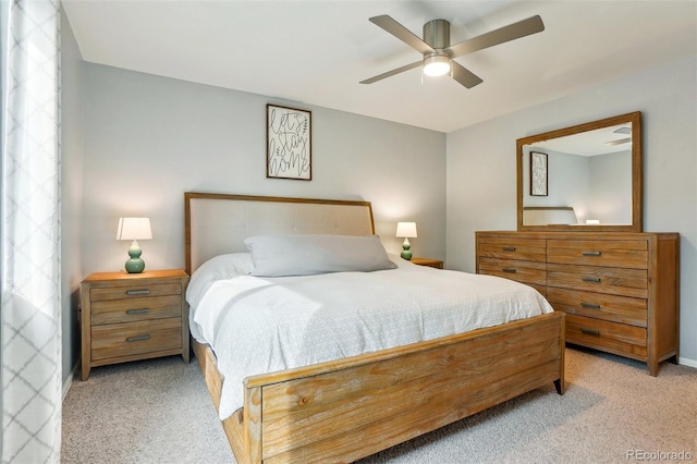 bedroom featuring light colored carpet and ceiling fan