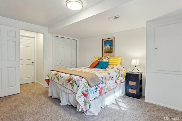 carpeted bedroom with a closet and baseboards