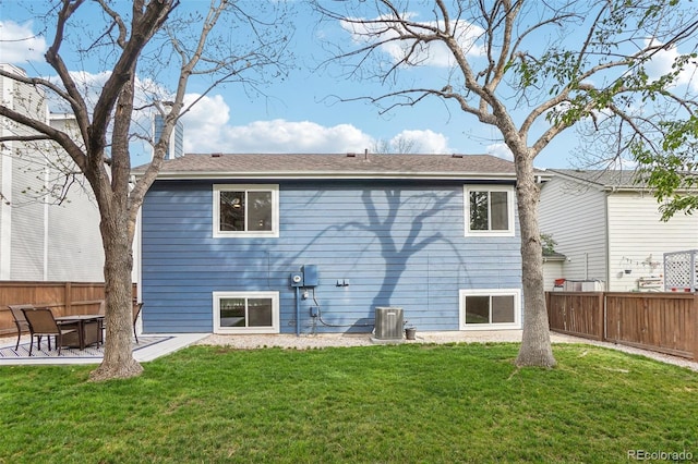 rear view of property with cooling unit and a patio