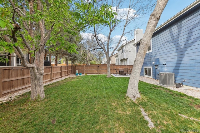 view of yard with central AC and a patio area