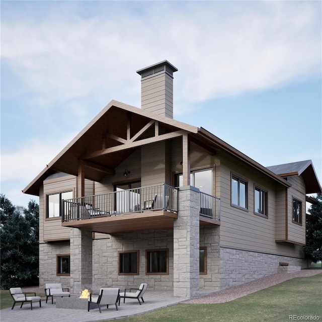 rear view of property with a balcony, stone siding, a chimney, outdoor lounge area, and a patio area
