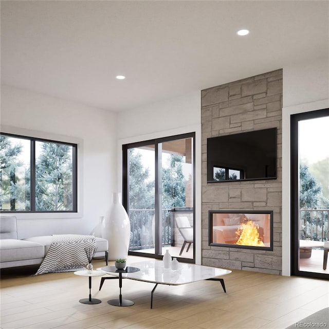 living room with a stone fireplace and recessed lighting