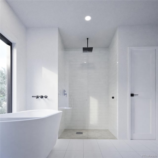 bathroom with tiled shower, a freestanding tub, tile patterned flooring, and recessed lighting
