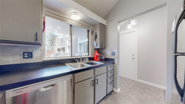 kitchen featuring dark countertops, dishwasher, vaulted ceiling, refrigerator, and a sink