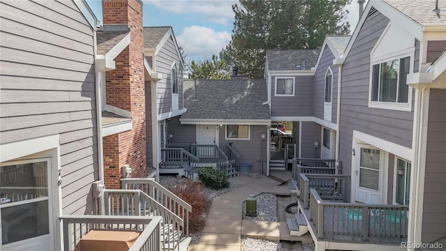 exterior space with roof with shingles