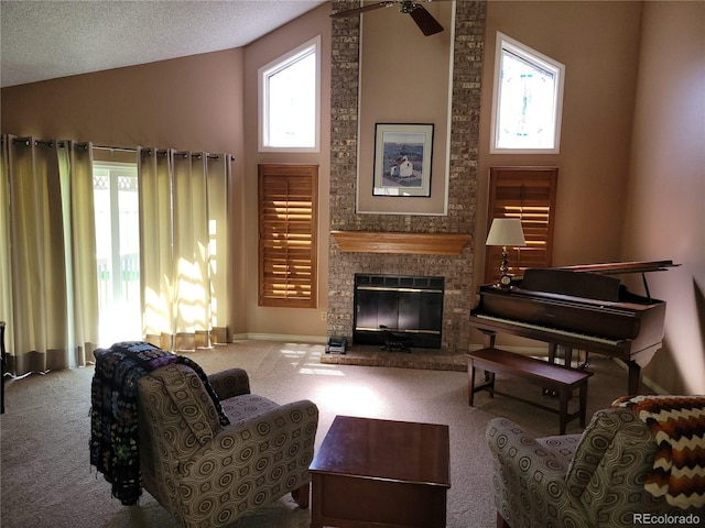 2619 S Iris Ct, Lakewood, CO 80227 - living area featuring carpet, healthy amount of natural light, a fireplace, high vaulted ceiling, and a ceiling fan