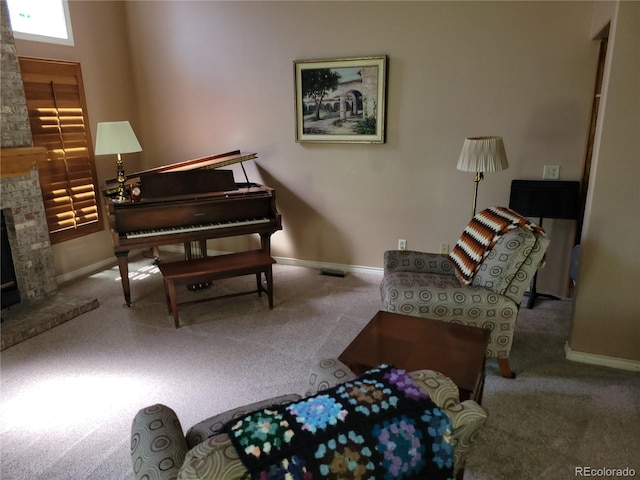 2619 S Iris Ct, Lakewood, CO 80227 - living area with carpet, a stone fireplace, and baseboards