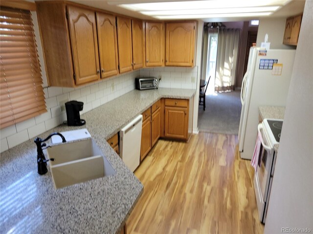 2619 S Iris Ct, Lakewood, CO 80227 - kitchen featuring white appliances, a sink, light wood-style floors, and decorative backsplash