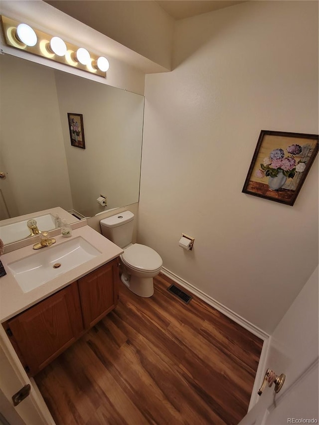 2619 S Iris Ct, Lakewood, CO 80227 - bathroom with wood finished floors, toilet, and vanity