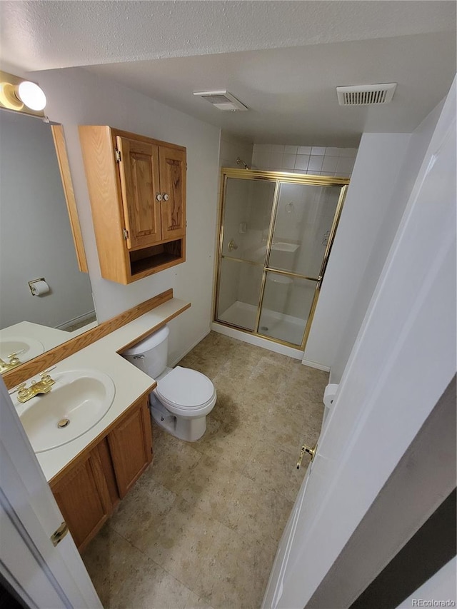 2619 S Iris Ct, Lakewood, CO 80227 - bathroom featuring a stall shower, vanity, toilet, and a textured ceiling