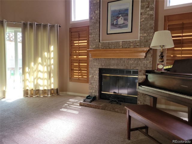 2619 S Iris Ct, Lakewood, CO 80227 - carpeted living room featuring a glass covered fireplace, baseboards, and a towering ceiling